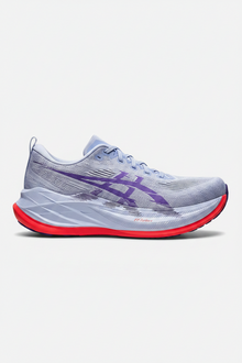 Gray running shoes with purple logo and red soles on a white background